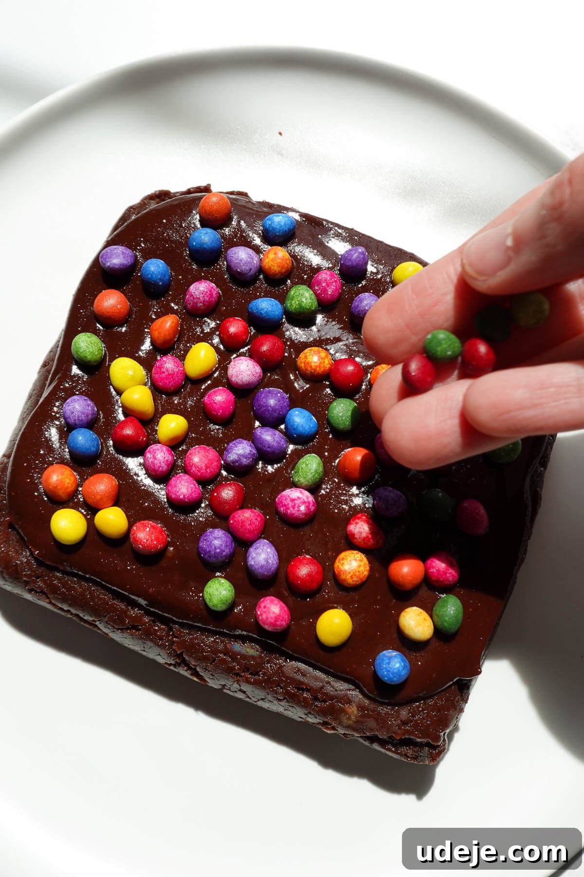 No-Bake Vegan Gluten-Free Cosmic Brownies (Small Batch) 9 Adding sprinkles on top of no bake cosmic brownies.