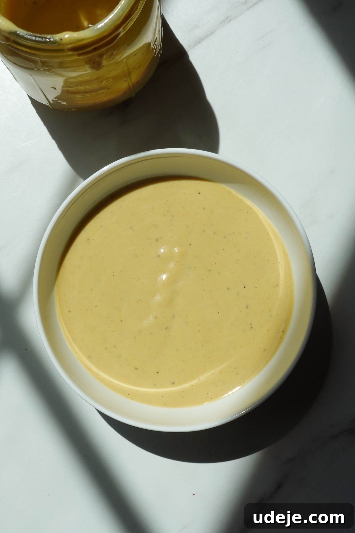 Roasted Sweet Potato & Chickpea Salad with Vegan Honey-Mustard Dressing 7 Creamy vegan honey mustard dressing in a bowl.