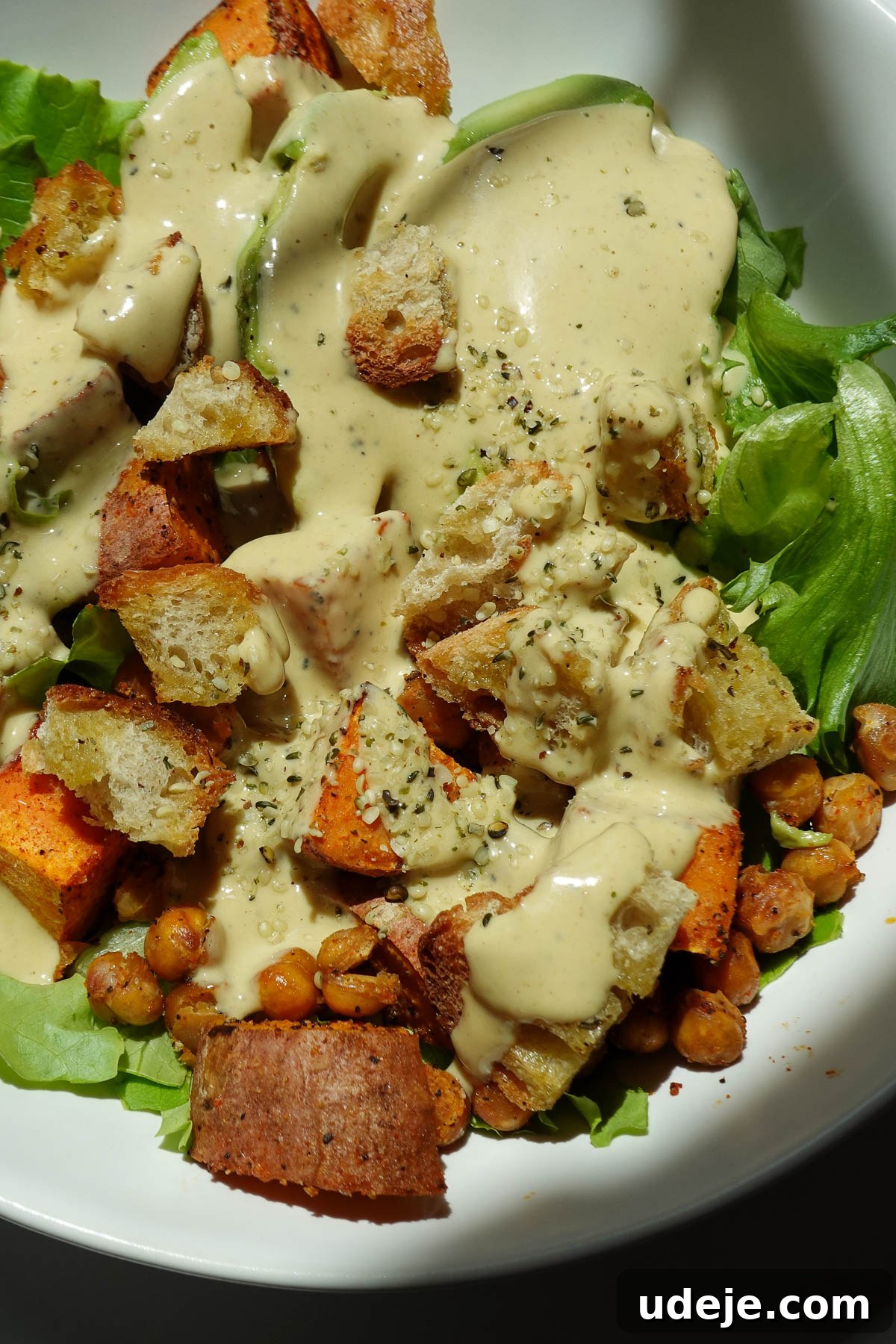 Roasted Sweet Potato & Chickpea Salad with Vegan Honey-Mustard Dressing 10 Sweet potato chickpea salad in a bowl topped with vegan honey mustard dressing.