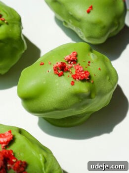 strawberry matcha stuffed date with creamy strawberry yogurt filling and green matcha coating