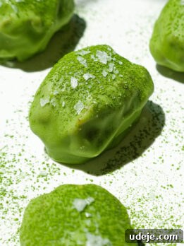 Close up of chewy medjool dates filled with vegan yogurt and dipped in matcha white chocolate