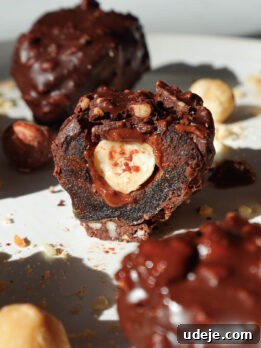Inside view of ferrero rocher stuffed date showing creamy hazelnut butter and a whole hazelnut