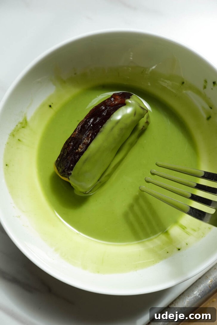 Pistachio and Matcha Stuffed Medjool Dates 7 Dipping stuffed dates into melted matcha white chocolate coating.