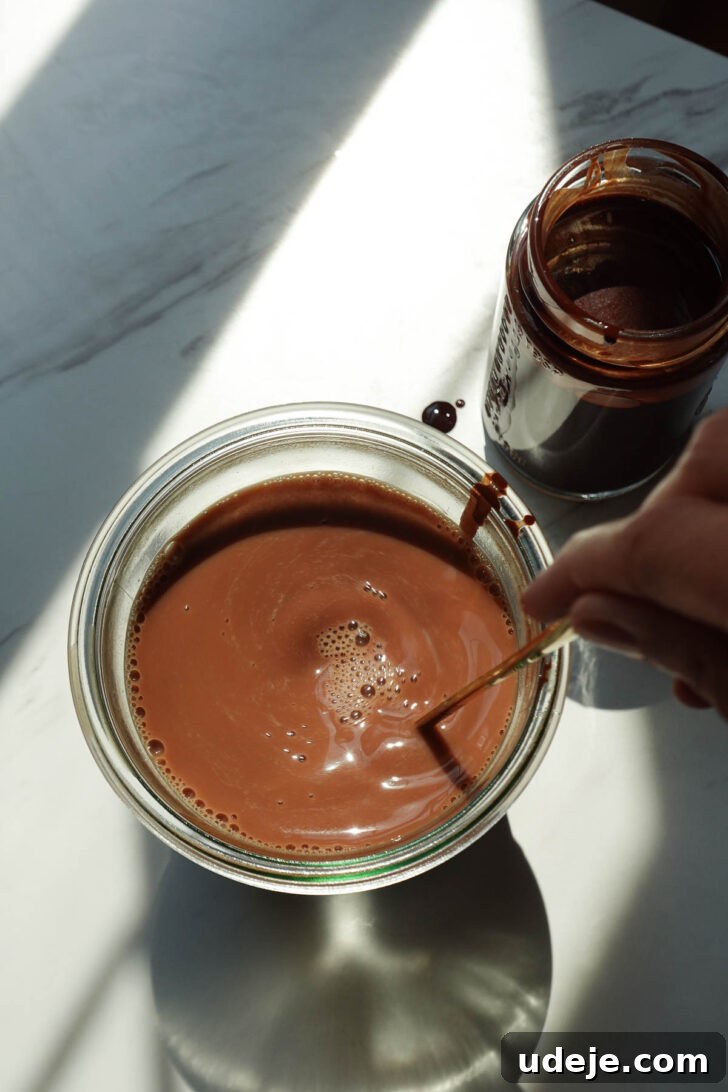 Glass of homemade chocolate milk made with oat milk and homemade chocolate syrup.