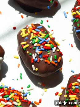 Cosmic brownie stuffed medjool dates with rainbow sprinkles on a white plate