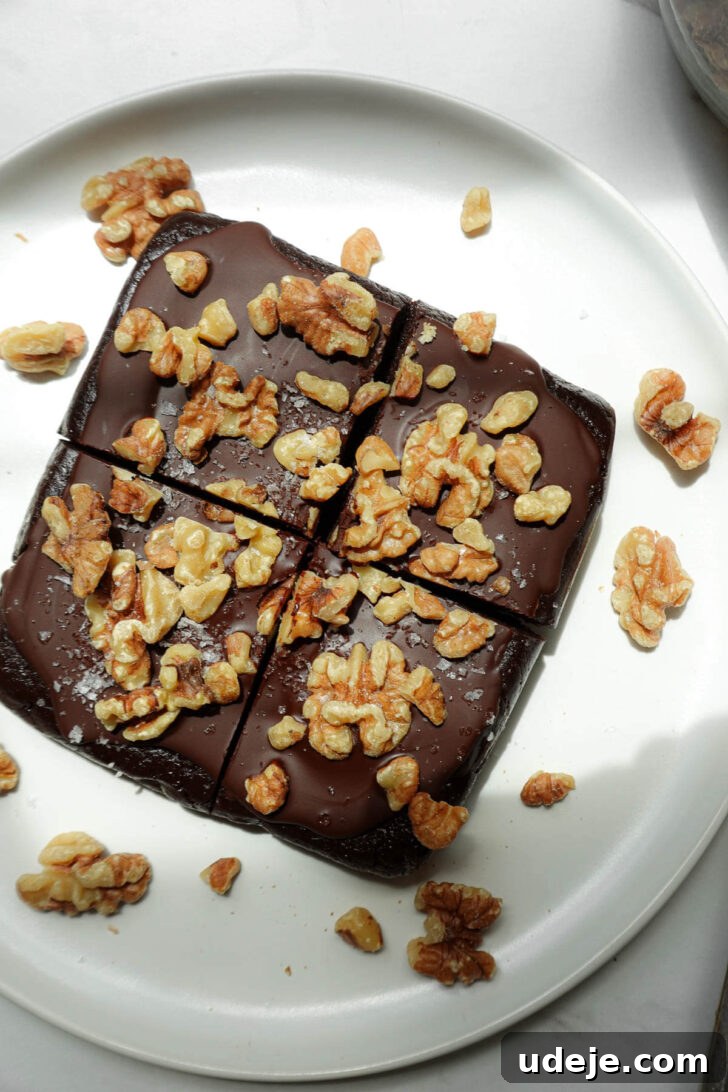 Fudgy Walnut Date Brownies Recipe 6 No bake walnut date brownies topped with vegan chocolate and walnuts.