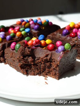 No bake cosmic brownie with a bite taken out, showing it's fudgy texture.