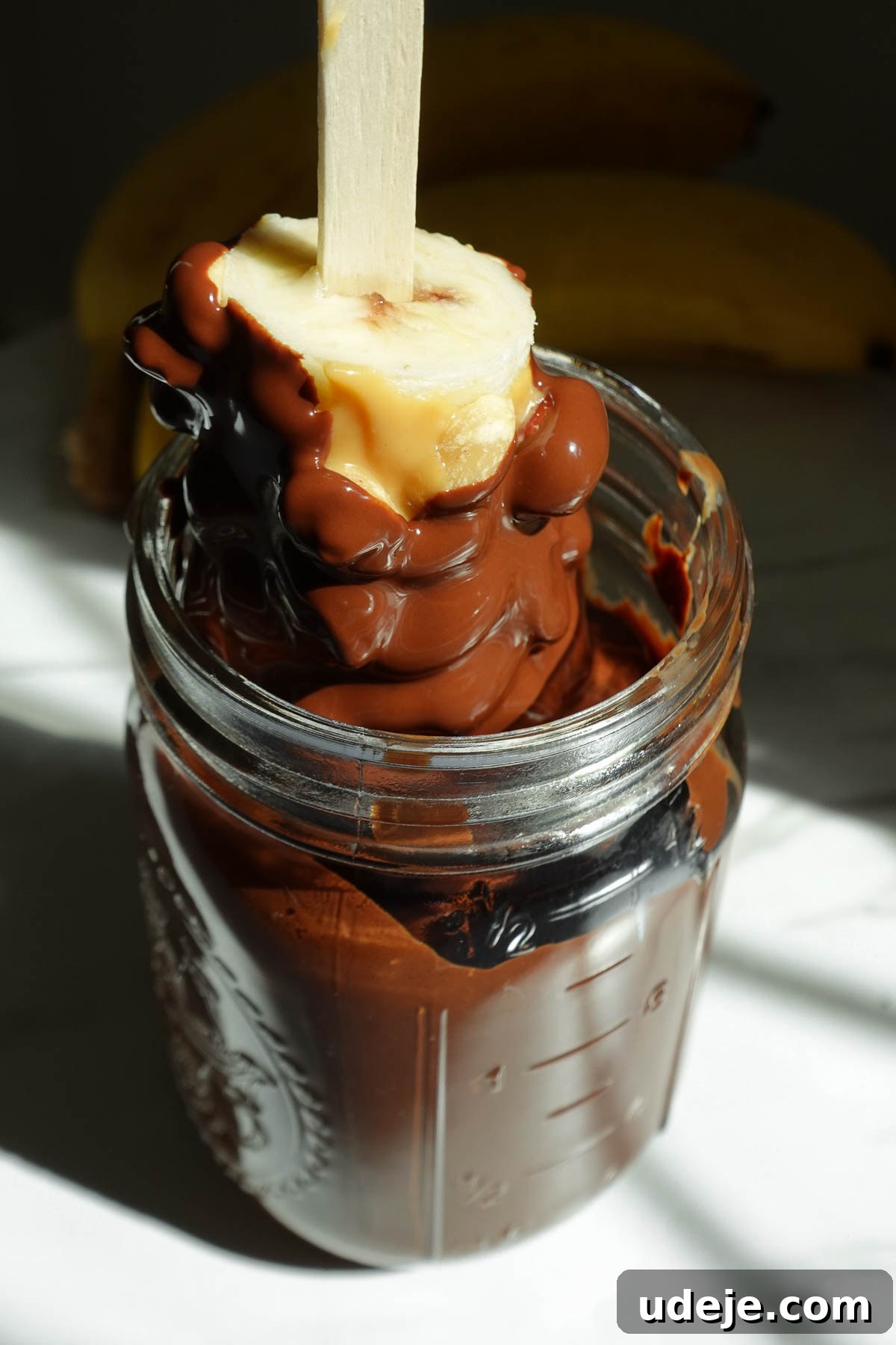 Snickers-Stuffed Frozen Banana Pops 10 Dipping frozen banana pops in chocolate