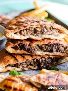 Pita stuffed with ground beef and grilled, stacked in a pile of three