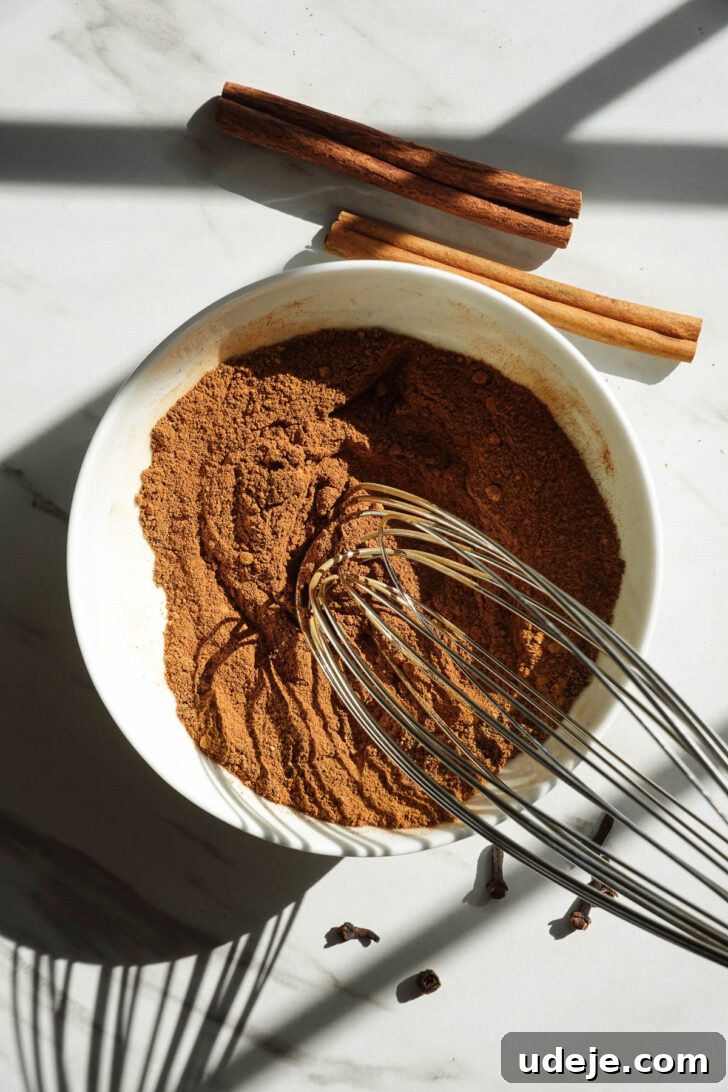 Homemade Pumpkin Pie Spice Blend Recipe 7 Ground spices being whisked together to make homemade pumpkin pie spice.